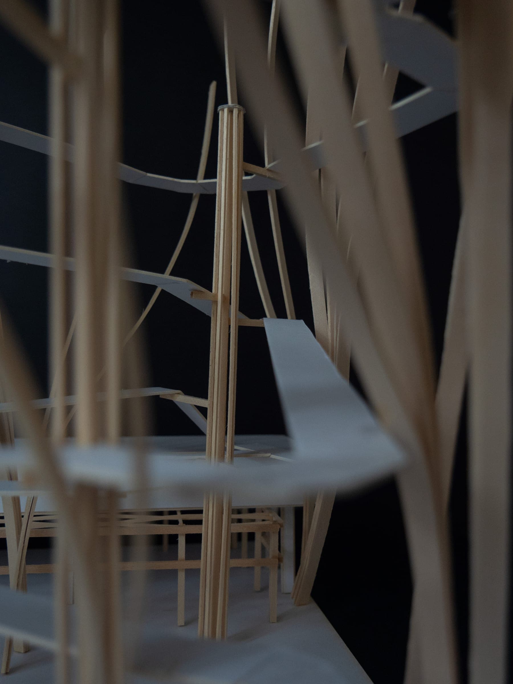 Close view into the card and wood model, walkways behind slender timber posts